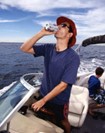 Photo of A man operating a motorboat while consuming alcohol on Wisconsin waters